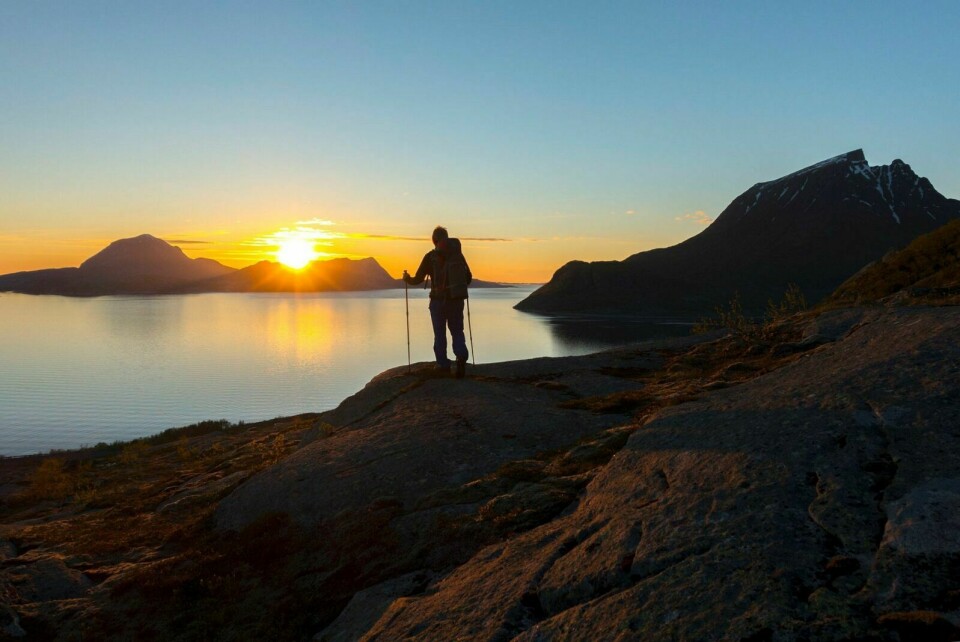 BEST I NORD: Mann på topptur i solnedgang på Helgelandskysten. Nord-Norge blir den store værvinneren til helgen til tross for kjøligere temperaturer. Foto: Gorm Kallestad / NTB